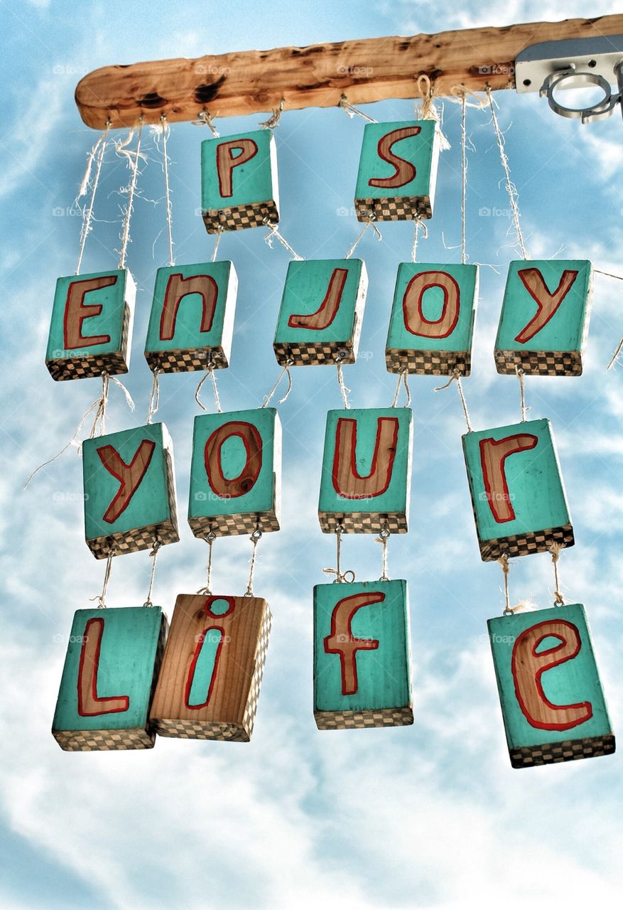 Sign enjoy your life.  A sign above a crafters tent. Look nice with blue sky background! 