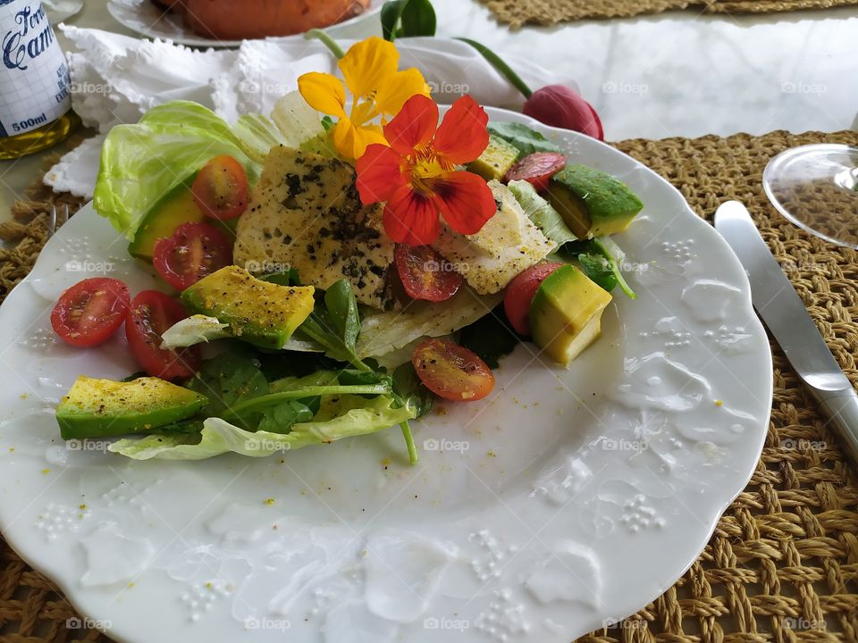 a lovely and delicious salad with capuchinha  flowers, lettuce, avocado, gorgonzola and spices