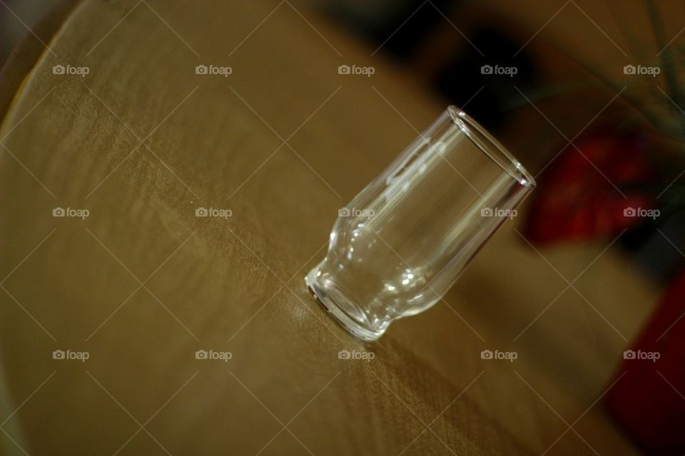 GLASS CUP ON A TABLE