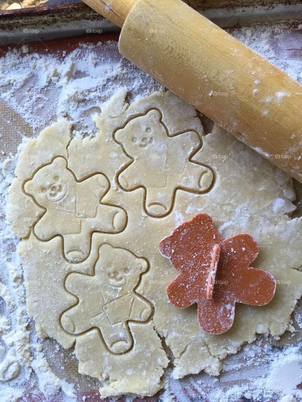 Cutting out teddy bear cookies
