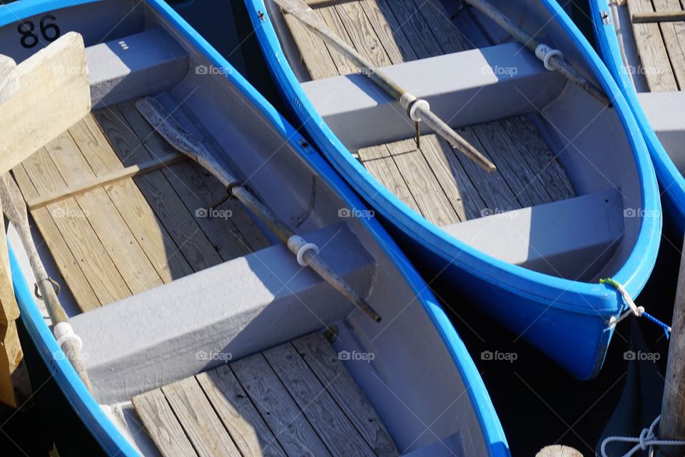 Blue boats moored at harbor