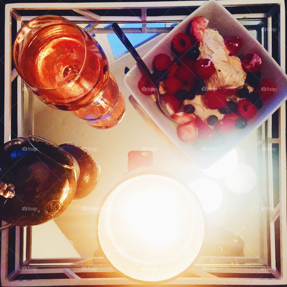 Perfect Night. My perfect night, a tray filled with wine, a plant, a candle, and a bowl of ice cream with berries. 