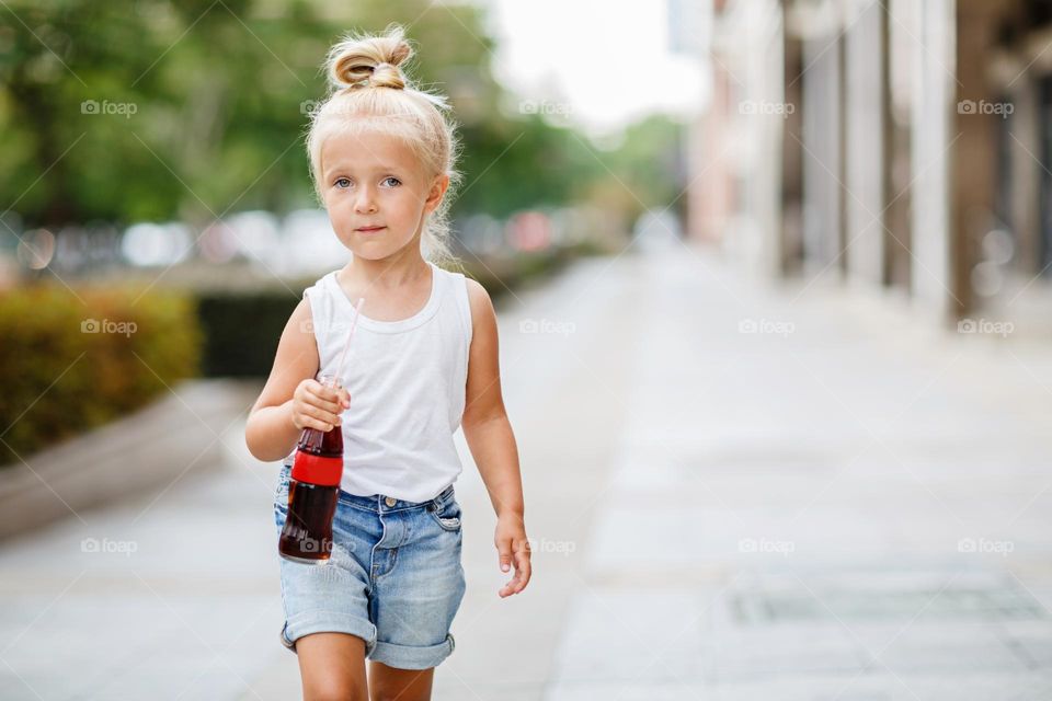 Stylish Caucasian girl walking outdoor at sunny 