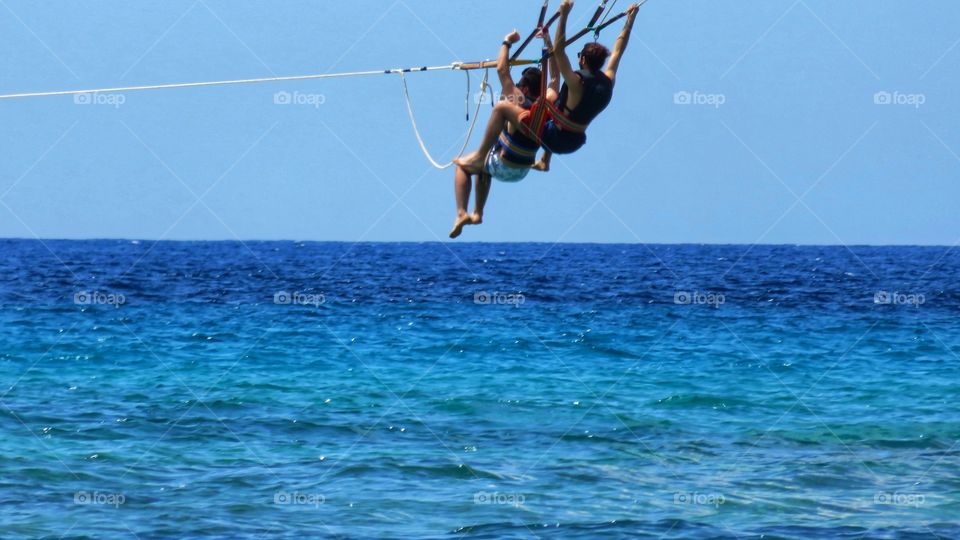 Young people practice parasailing