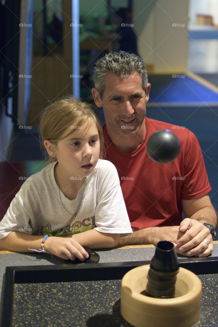 Father and daughter playing in home