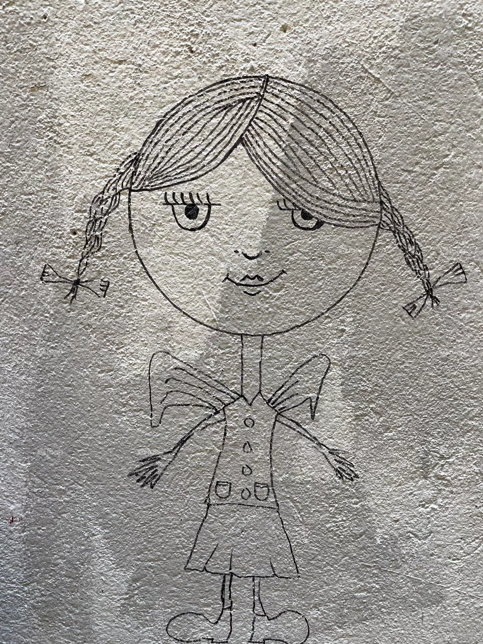 Wall art work which shows a small girl with beautiful hair 