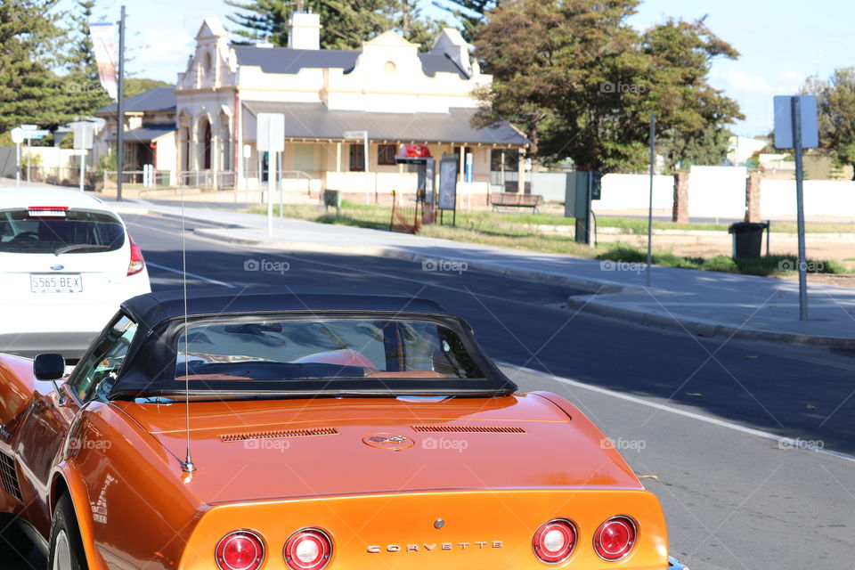 Orange corvette convertible parked on street classic cars