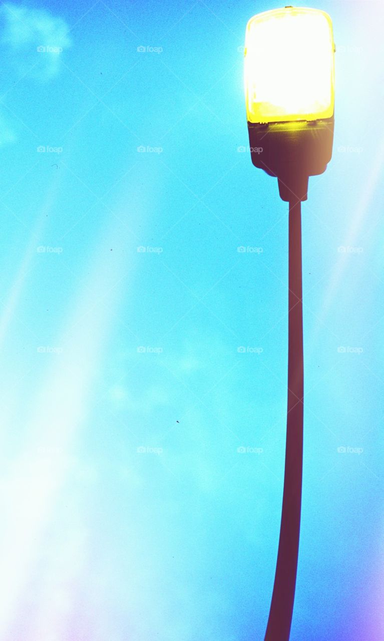 Lampost on during the day