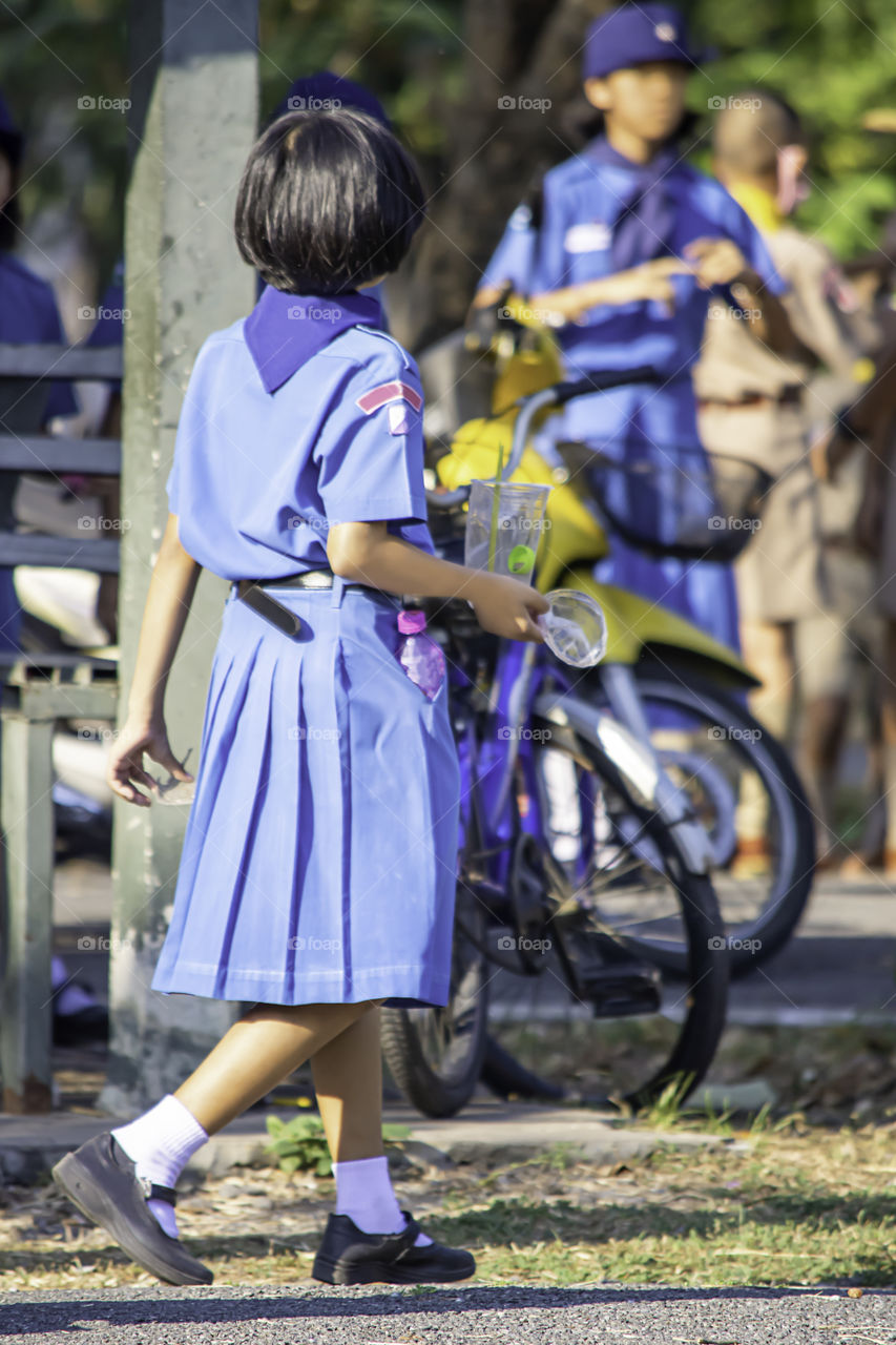 Hand Asean girl holding a glass of waste plastic and Drinking straws colorful.