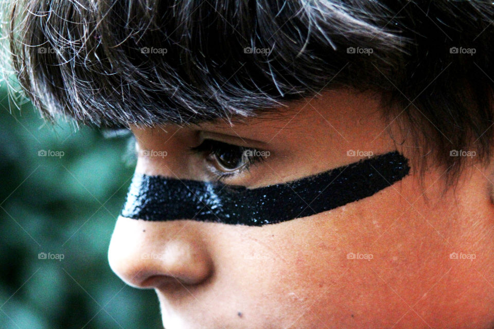 Close-up of boy's face with black face paint