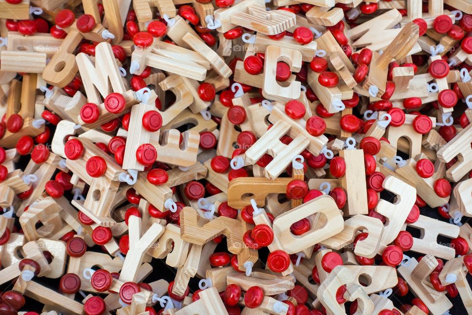Pile of wooden letters with red wheels