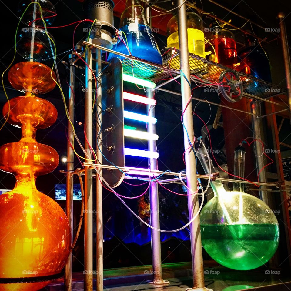 Uniquely shaped bottles and beakers filled with colorful liquids to look like a mad scientist lab.