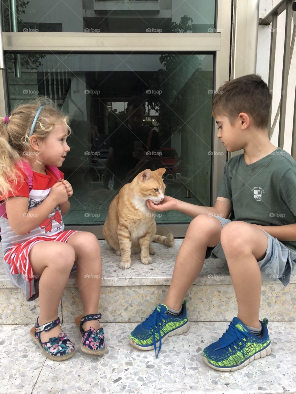Kids playing with cat 