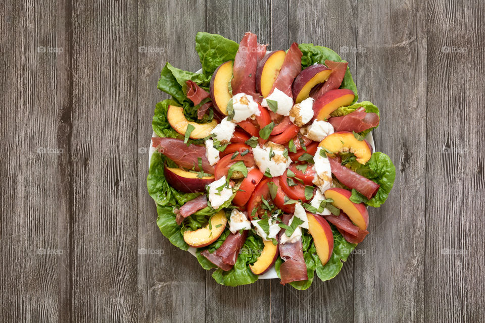 a colourful summer salad made with lettuce, tomatoes