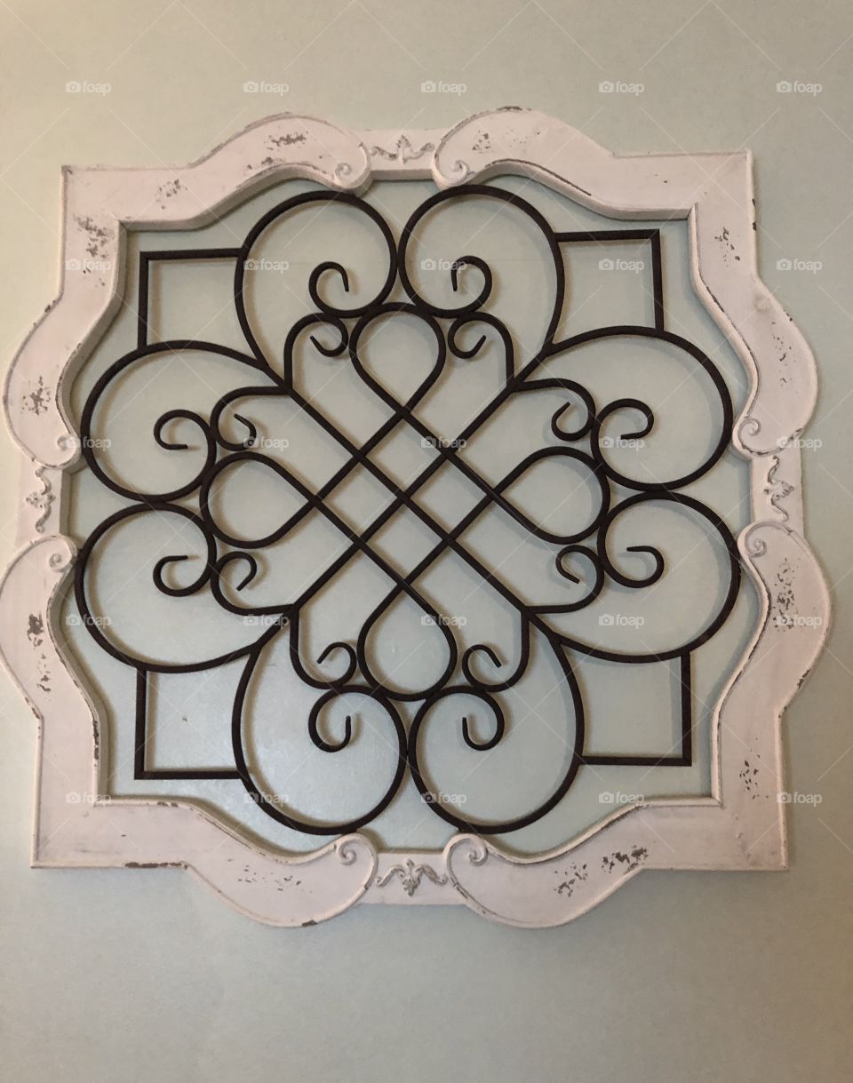 Design wrought iron in a wooden frame.