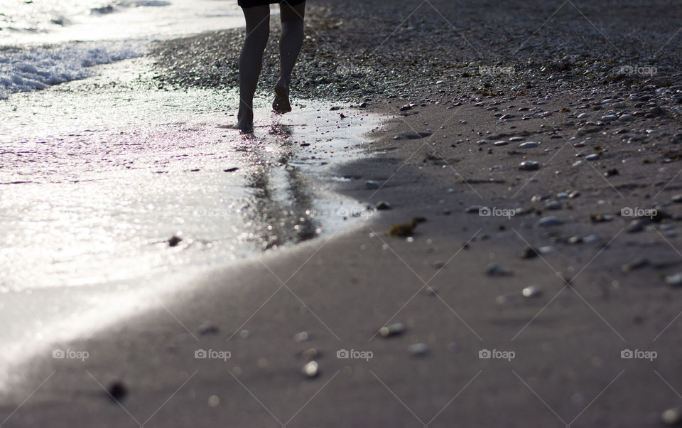 woman running on the beach. woman running on sandy beach in shallow sea