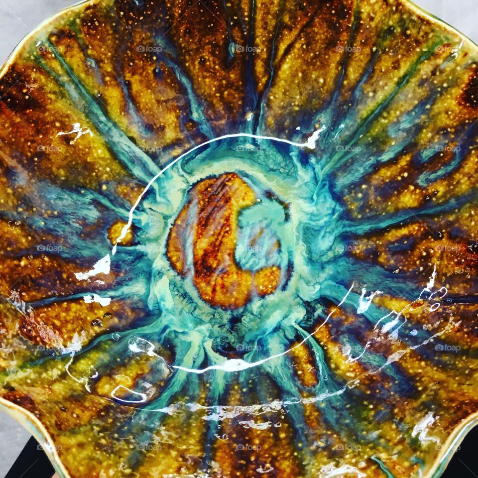 Runny, cone 6 glazes inside of a bowl
