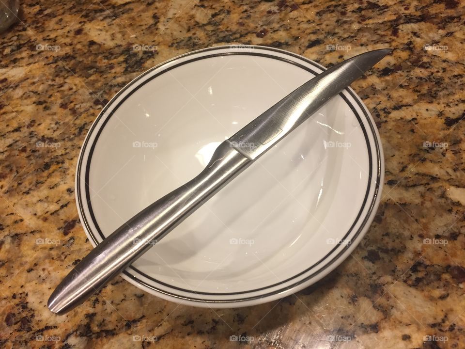 Knife and an empty white plate