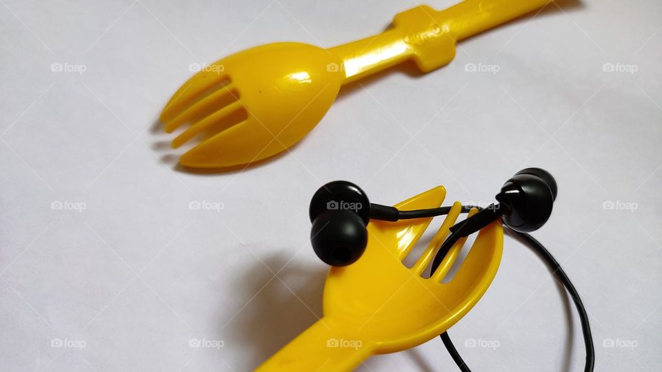 Yellow forks Trying to grab some music with earphones