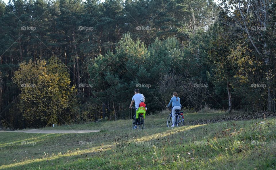 family riding bikes, nature landscape, social distance