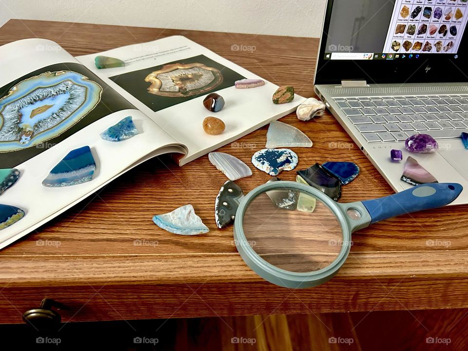 Desktop with rocks, book and laptop on top