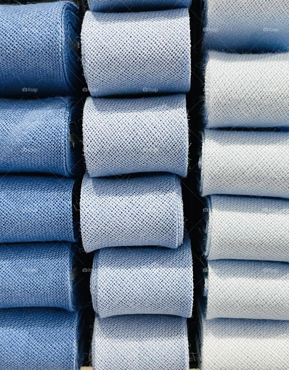 Cotton ribbons stacked in various nuances of baby blue