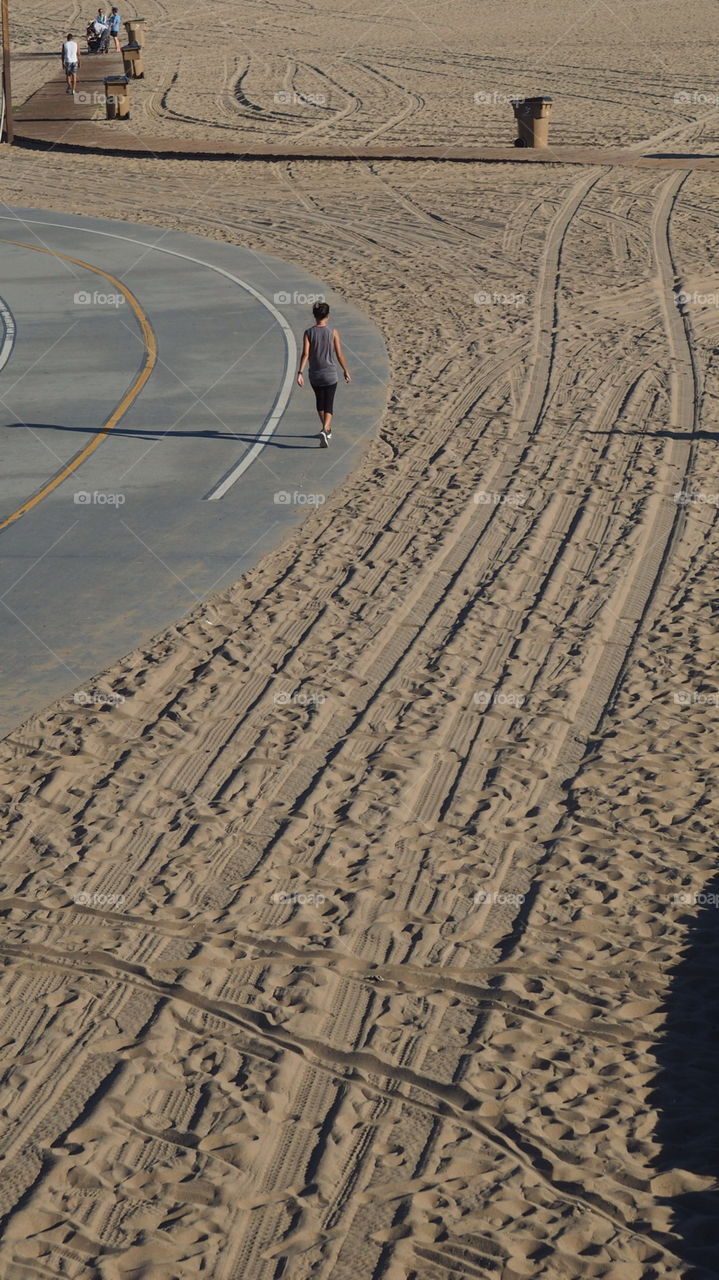 Santa Monica Beach runner. Runner jogger excercising in Santa Monica beach track sand fun