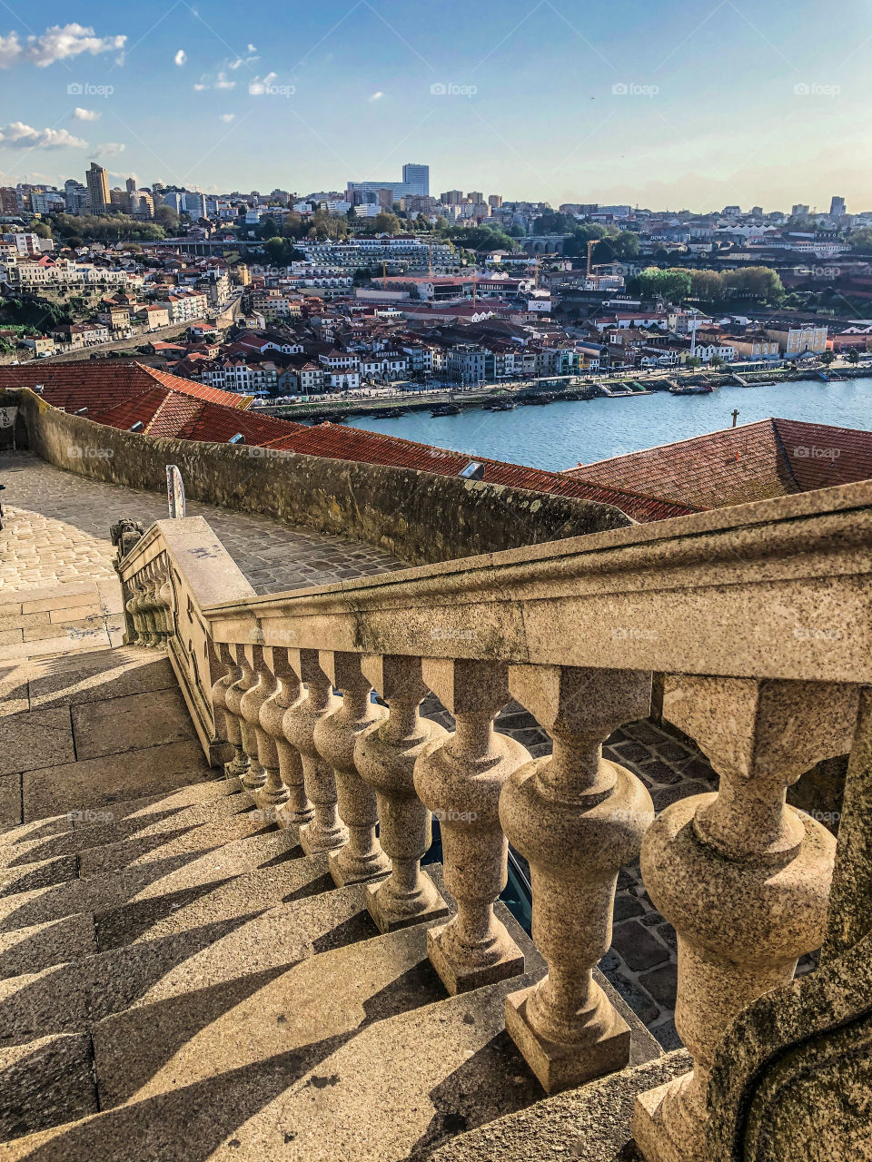 The view from up above a flight of stone steps leading down to Rio Douro and the city beyond