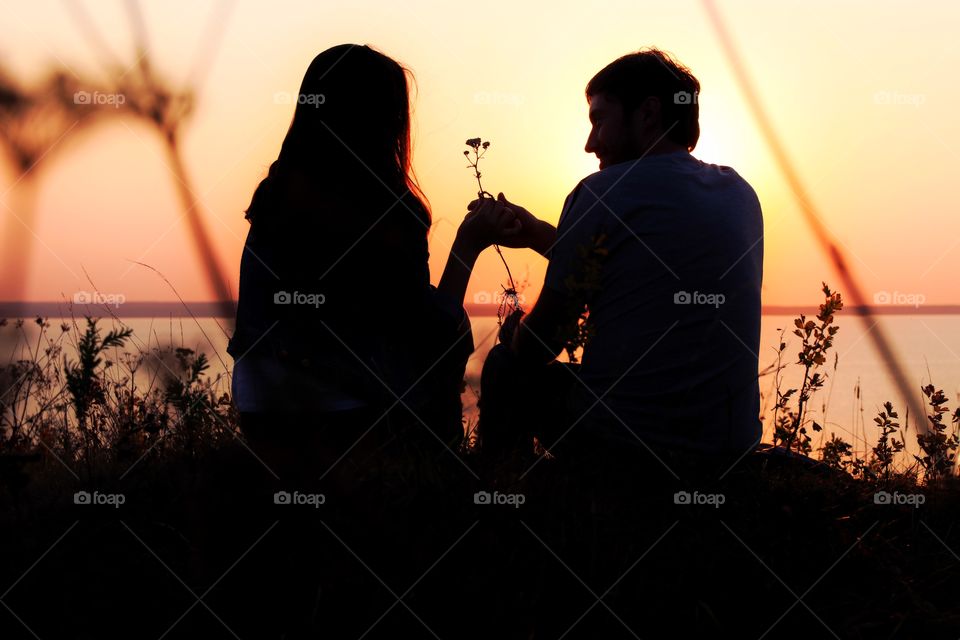 Silhouette of a couple in love on sunset 