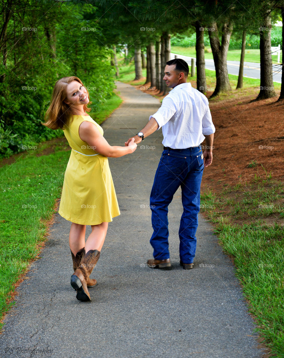 Young couple walking together on road