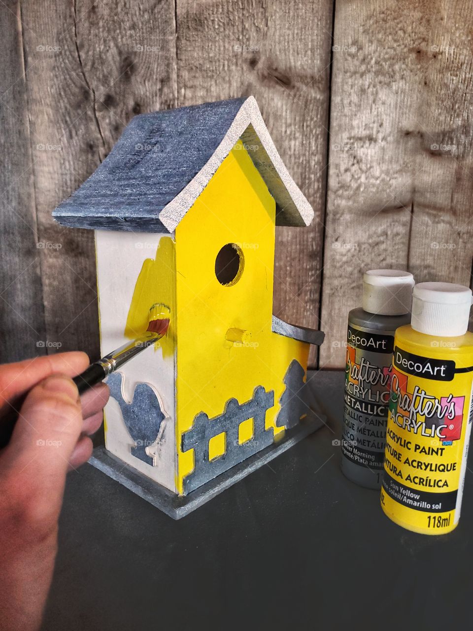 Painting a birdhouse.