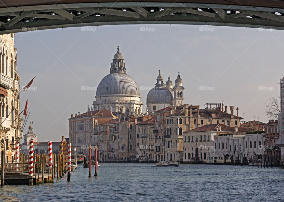Glimpse of the Grand Canal, from under the Rialto bridge, with the warm sunset light.