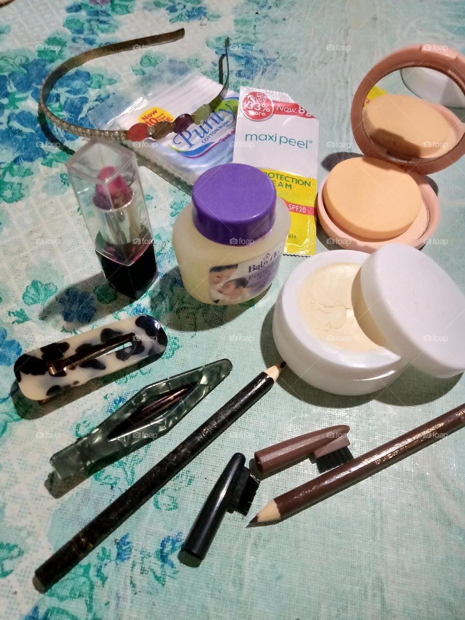 A VERY SIMPLE MALEUP PRODUCTS, L'CHEAR LIPSTICK, GOREE DAY CREAM, FACE POWDER, BLACK AND BROWN EYE LINER AND EYEBROW, SUNBLOCK, WITH TWO HAIRCLIPS AND HEADBAND,, COTTON BUDS AND PETROLEUM JELLY TO REMOVE MAKEUP