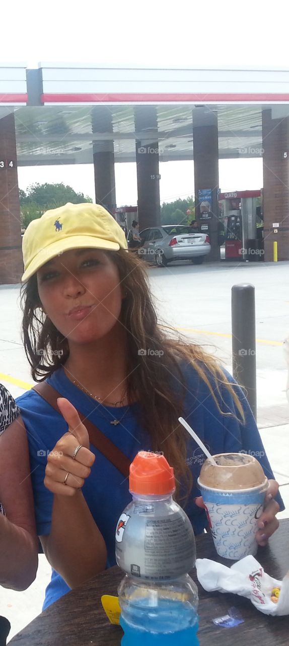 Teenage girl with a cap making a face.