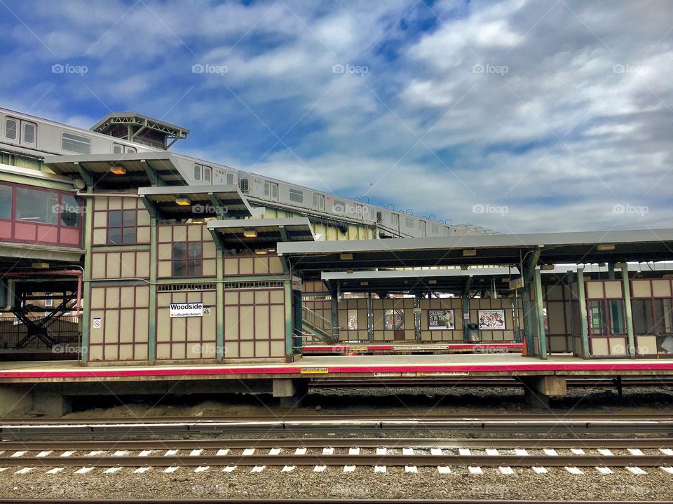 Empty Rail Platform at Station with Overhead Subway Car Passing in Queens, New York in 2017