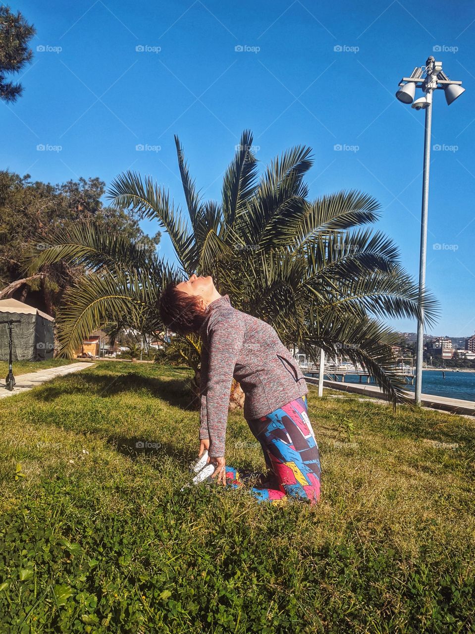 Portrait of beautiful young smiling woman doing yoga poses at the nature at spring. Healthy lifestyle
