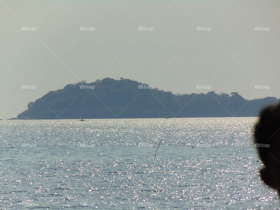 a photo of an island surrounded by the ocean