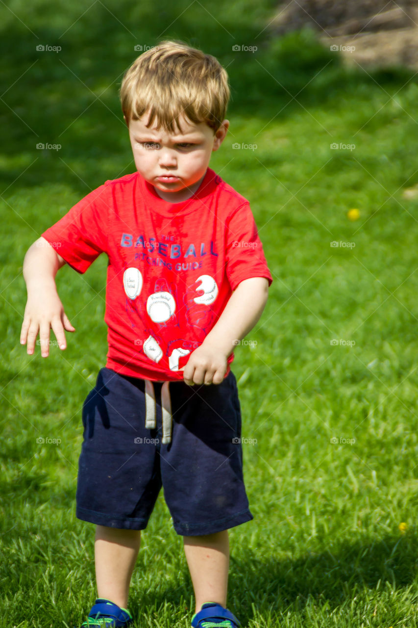 Portrait of cute boy standing on grass