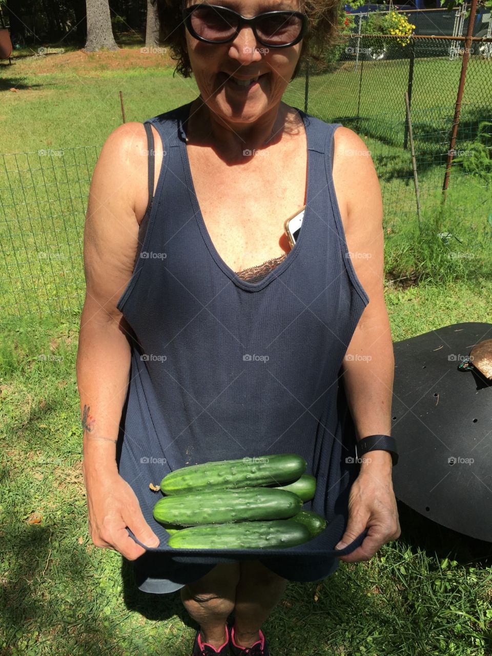 The read me, gardening. Sweaty, dirty, phone in bra, load of cukes in my shirt! LOL
