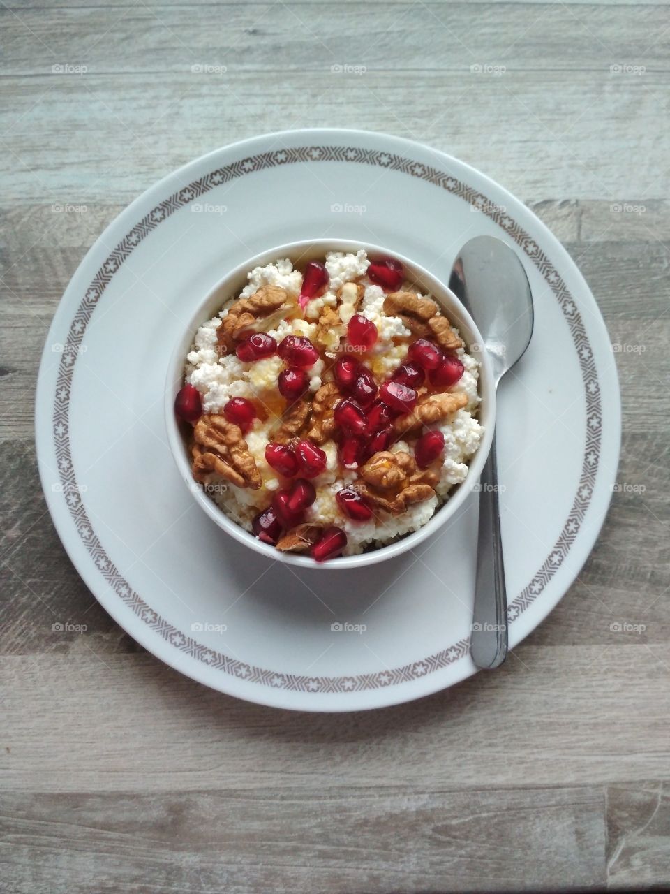 Healthy breakfast fresh cow cheese with nuts and honey.