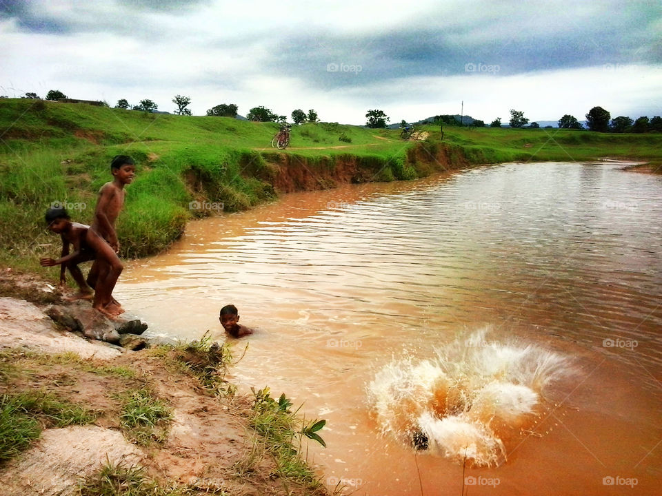 boys jumping on water