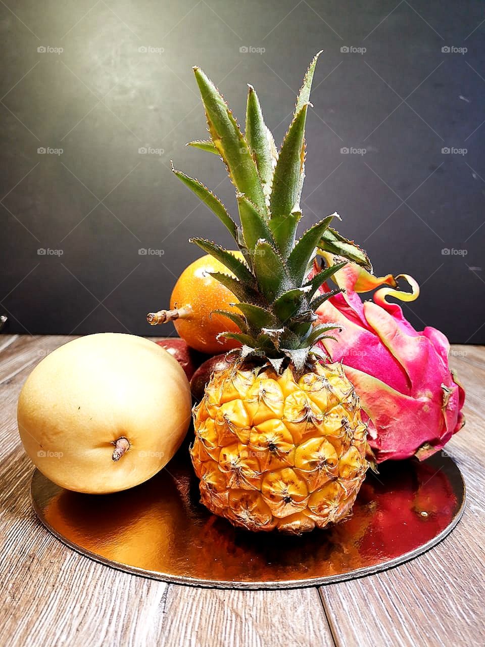 exotic fruits: pineapple, dragon fruit, mango