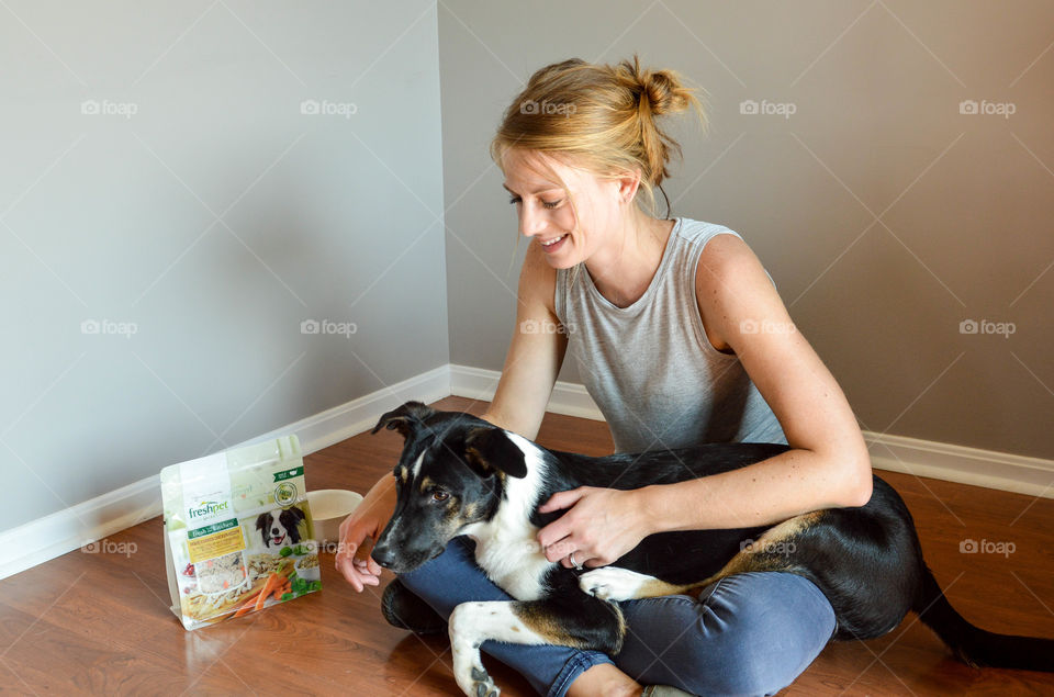 Woman smiling and holding her pet dog