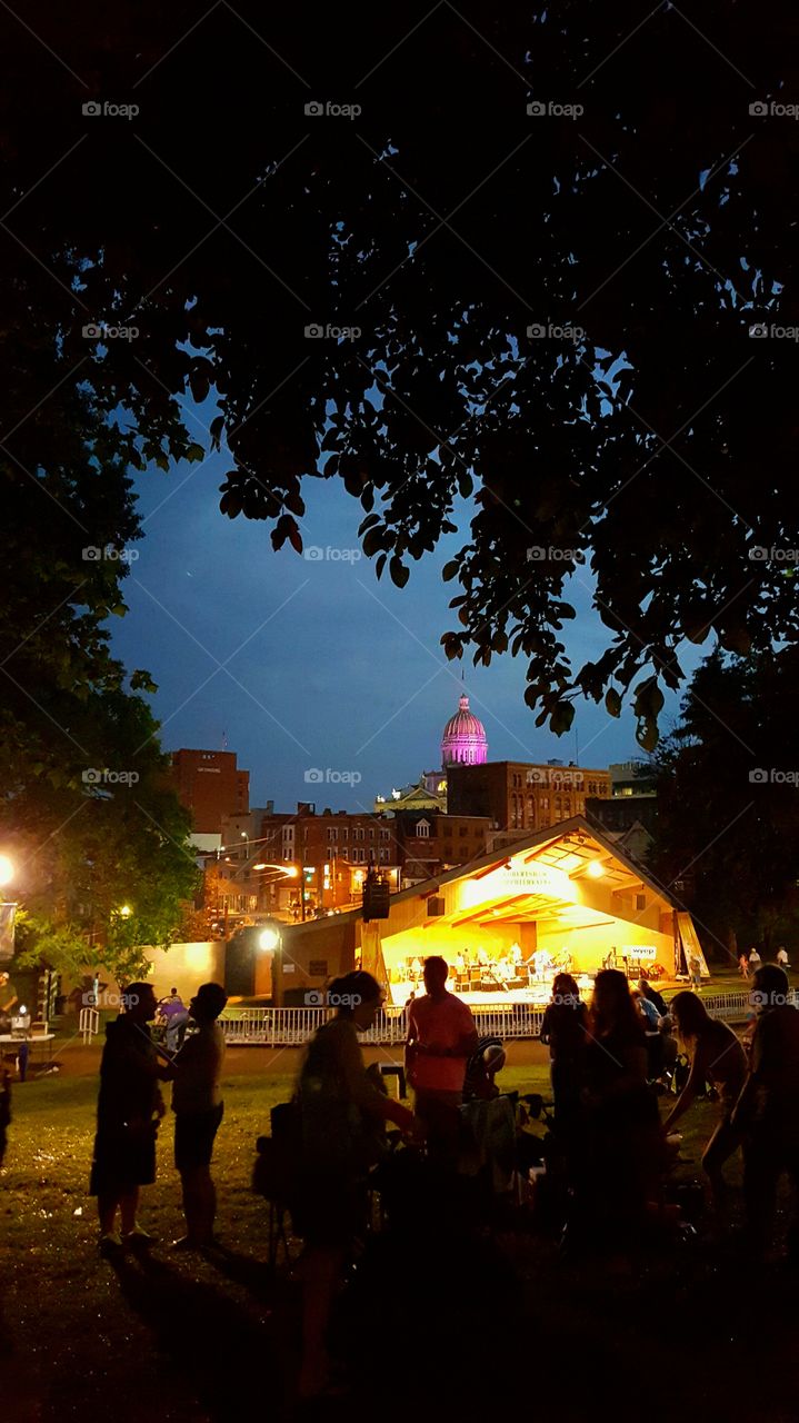 Music lovers  pack up and get ready to leave after a concert in a city park.