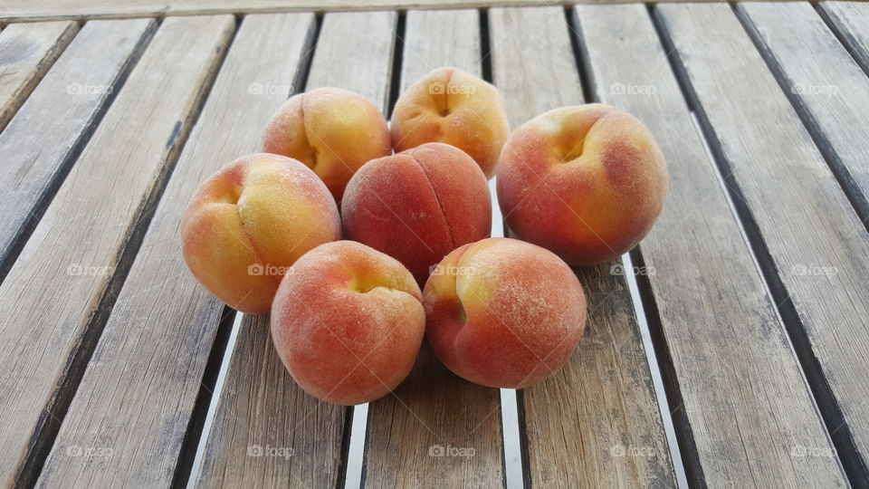 Peaches on wooden table