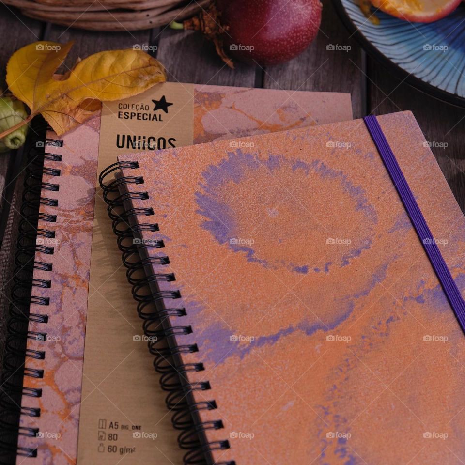 Two inspiring marbled notebooks accompanied by the sweetness of passion fruit