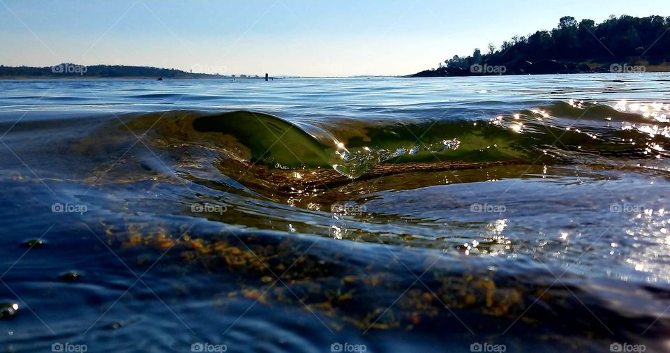 Clear wave breaking on a rock