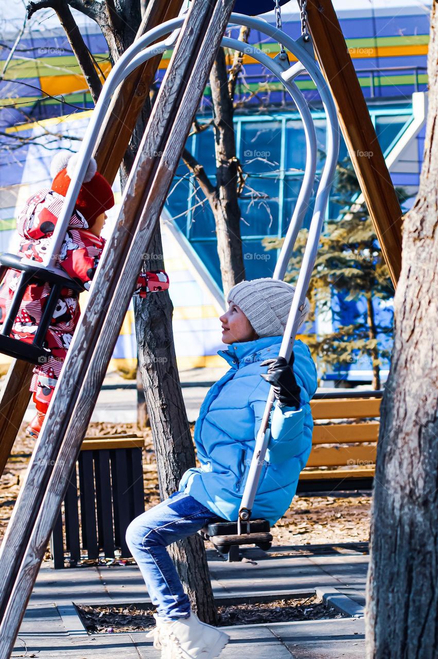 Children on a swing in the park