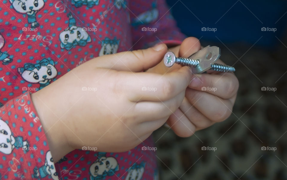 little girl holding tools