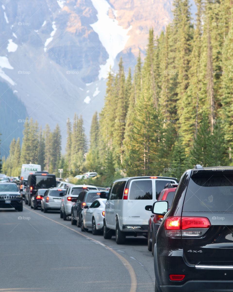 Heavy car auto traffic on the road in the Rocky Mountains near Lake Louise in the height of tourist season 